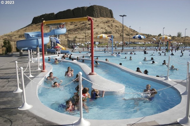 view of pool with a water slide