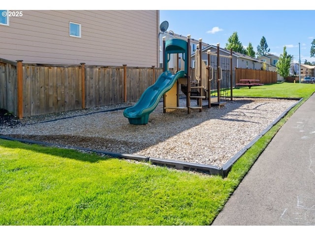 communal playground with fence and a yard