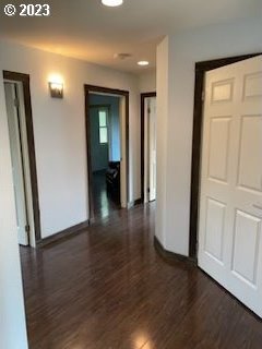 corridor with dark hardwood / wood-style floors