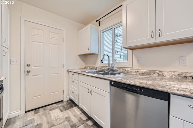 9832 N Clarendon Ave, Portland, OR 97203 - kitchen featuring stainless steel dishwasher, white cabinetry, and light wood-type flooring