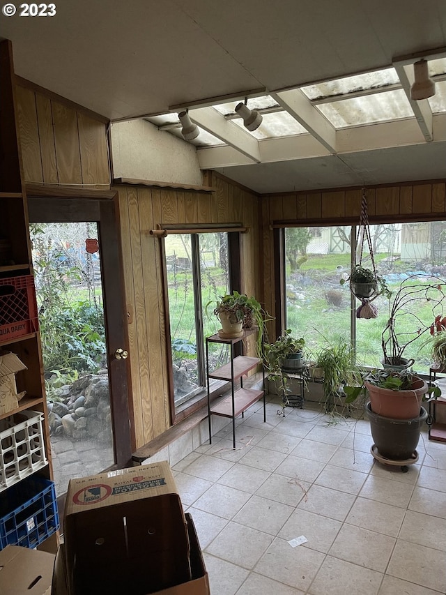 sunroom featuring a healthy amount of sunlight and a skylight