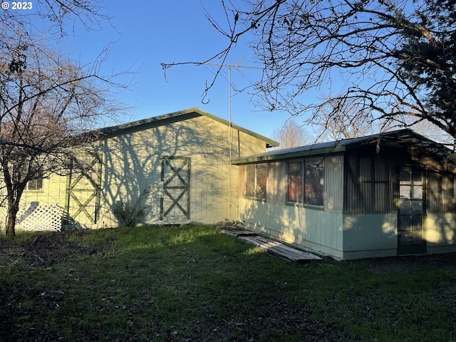 view of side of property with a yard