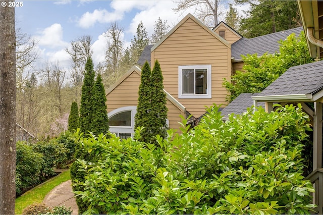 view of side of home featuring a shingled roof