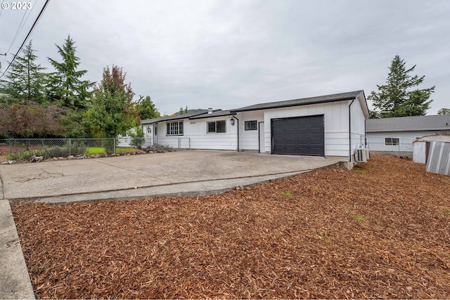 view of front of property with ac unit and a garage