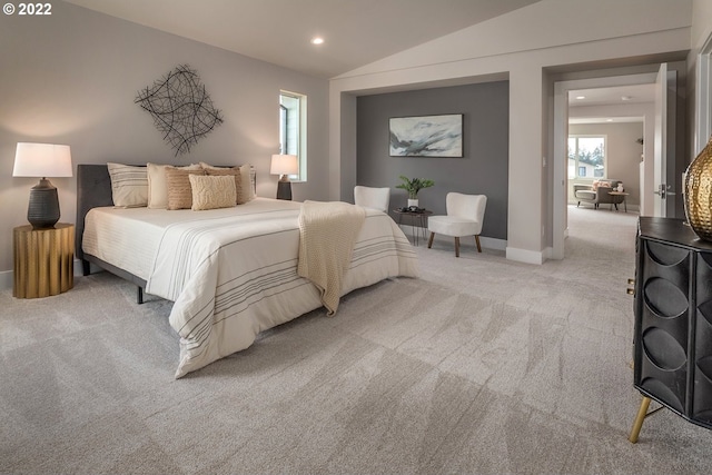 bedroom with lofted ceiling and light carpet