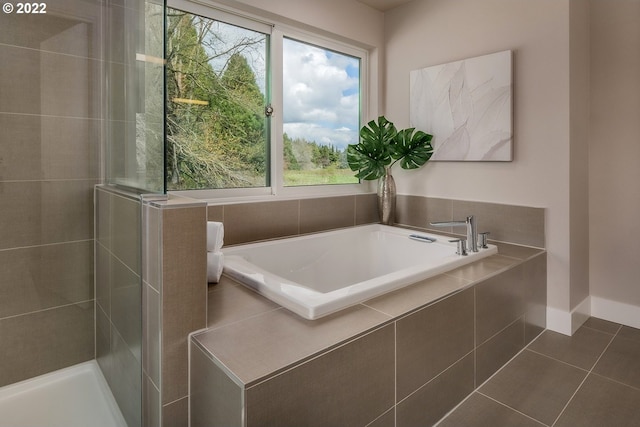 bathroom featuring tile patterned floors and separate shower and tub