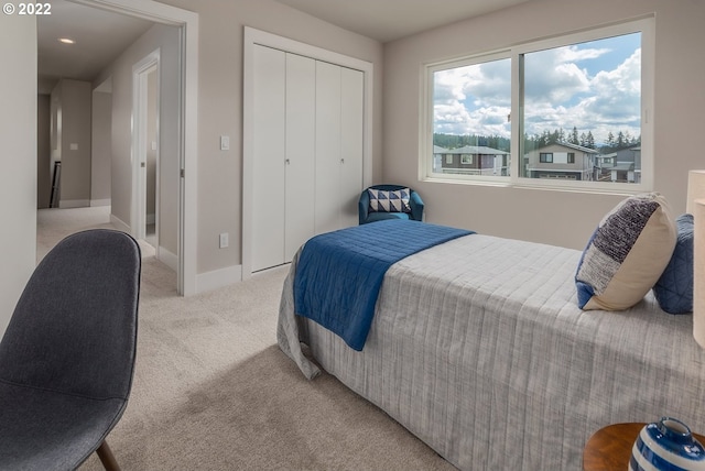 bedroom featuring a closet and light colored carpet