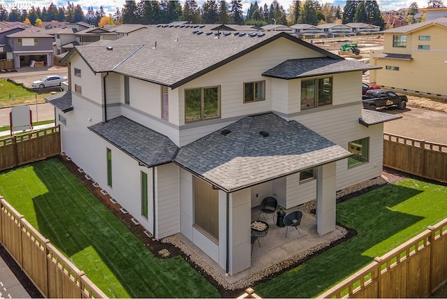 rear view of property featuring a yard and a patio