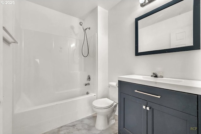 full bath featuring toilet, marble finish floor, vanity, and washtub / shower combination