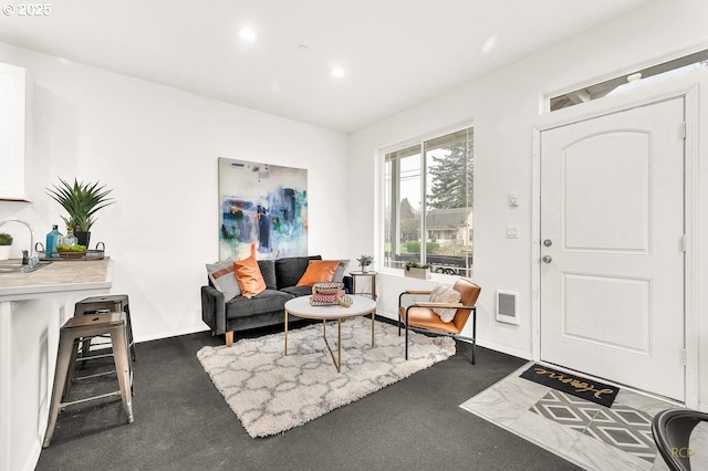 interior space featuring dark colored carpet, baseboards, and recessed lighting