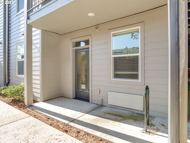 doorway to property with a balcony and a patio