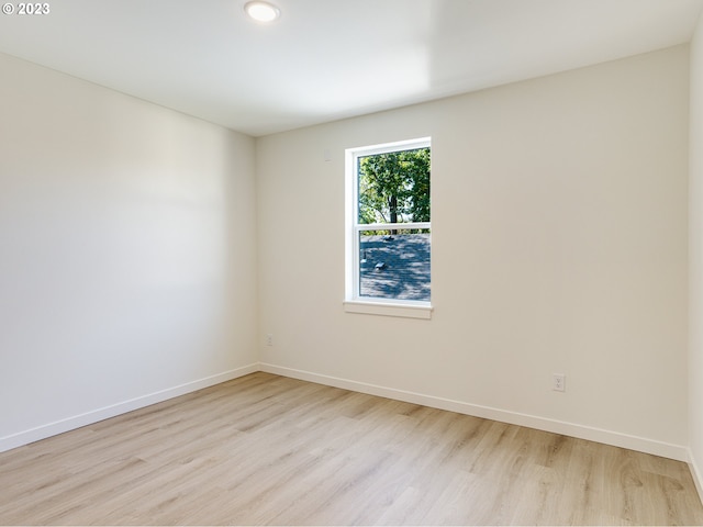 spare room featuring light hardwood / wood-style floors