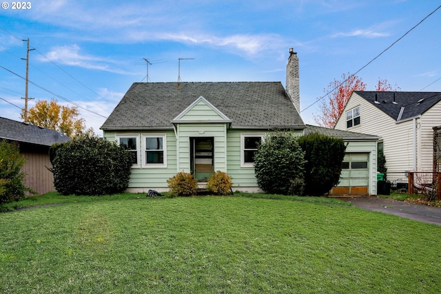 bungalow-style home with a garage and a front lawn