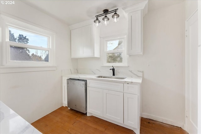 kitchen featuring dishwasher, a healthy amount of sunlight, sink, and light hardwood / wood-style flooring