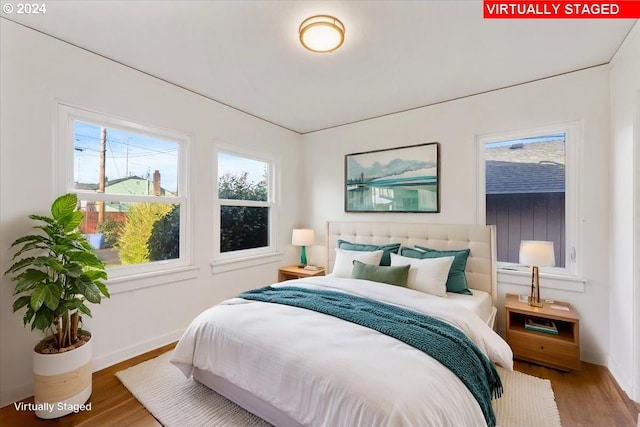 bedroom with hardwood / wood-style floors