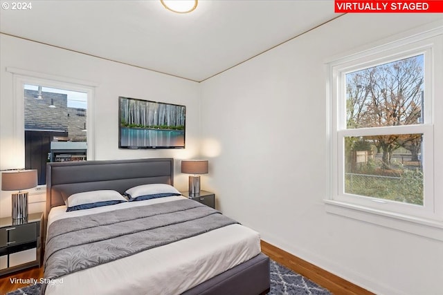 bedroom featuring hardwood / wood-style flooring and multiple windows