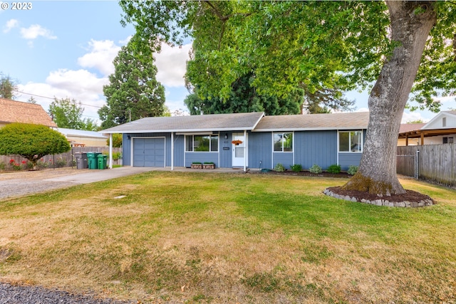 ranch-style house with a garage and a front lawn