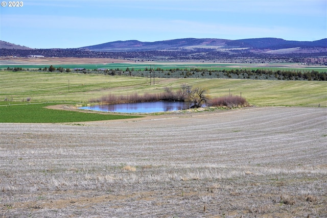 property view of mountains with a rural view and a water view