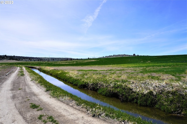 exterior space with a rural view and a water view