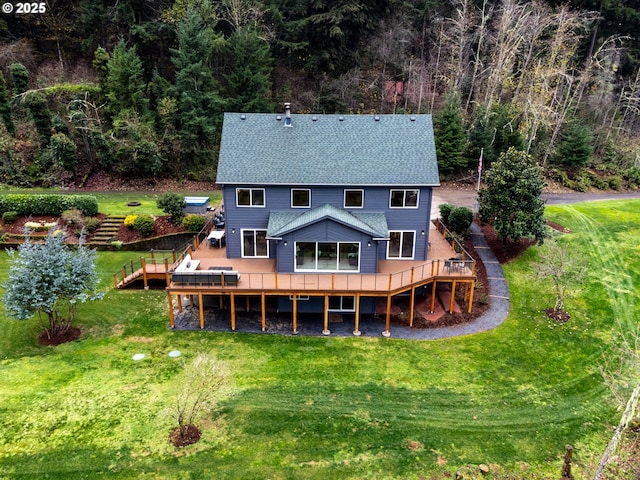 back of house with a wooden deck and a yard