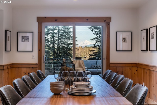 dining space featuring wooden walls