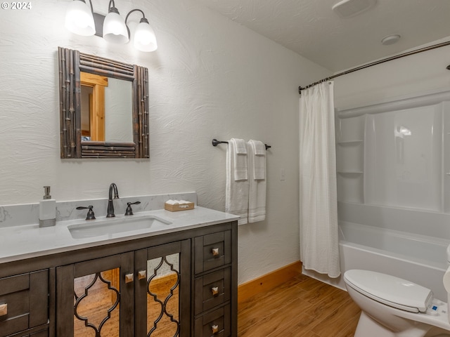 full bathroom featuring wood-type flooring, toilet, shower / bath combo with shower curtain, and vanity