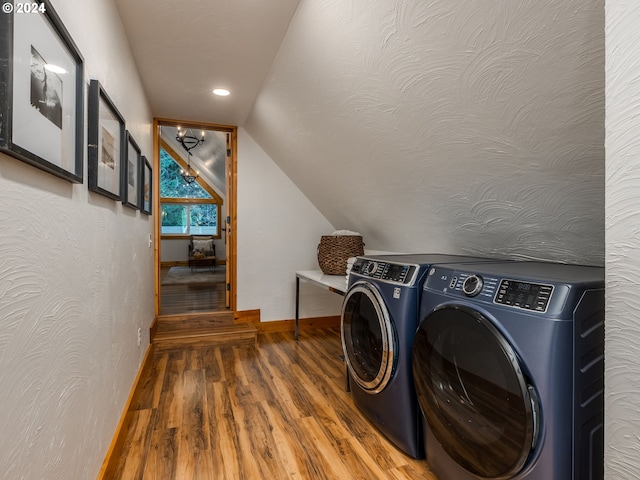 laundry room featuring separate washer and dryer, hardwood / wood-style floors, and a textured ceiling