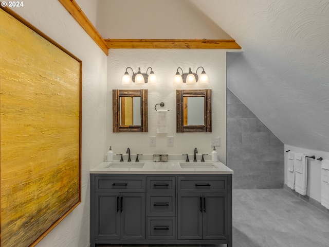 bathroom featuring vanity and lofted ceiling