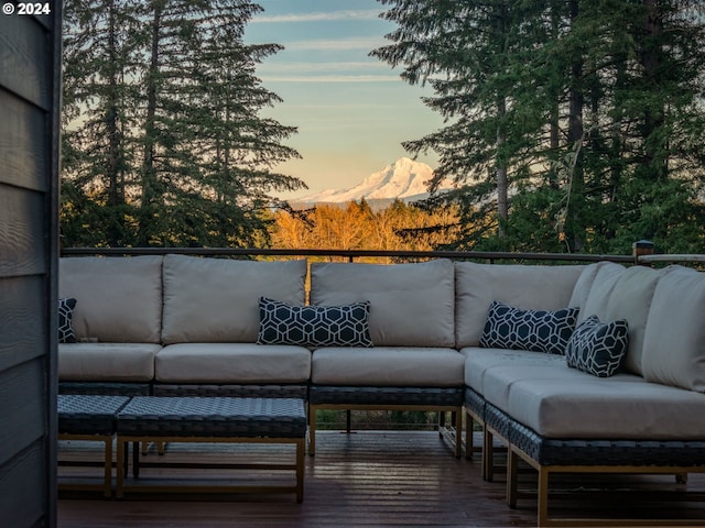 deck at dusk featuring an outdoor living space