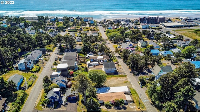 birds eye view of property with a beach view and a water view