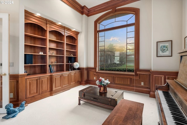 living area with crown molding, a wealth of natural light, and light colored carpet