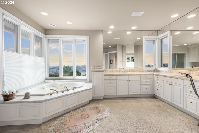 bathroom with tile flooring, dual bowl vanity, and tiled bath