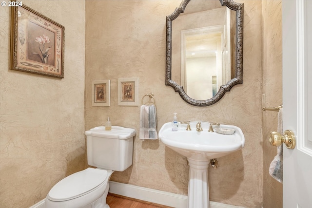 bathroom featuring toilet and hardwood / wood-style floors