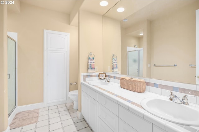 bathroom with toilet, dual bowl vanity, tile floors, and an enclosed shower