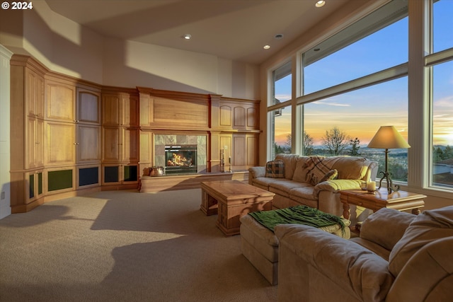 living room with light colored carpet and a high ceiling