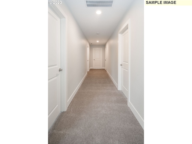 hallway with light colored carpet