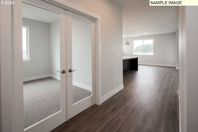 hallway with french doors and dark hardwood / wood-style flooring