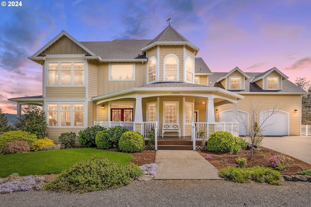 view of front of property featuring a porch and a garage