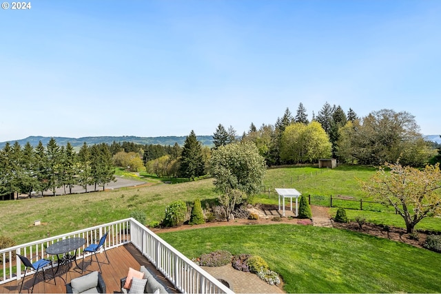 view of yard with a rural view and a deck