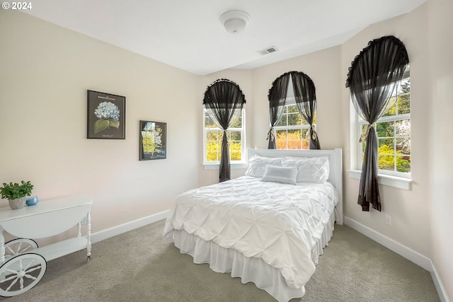 bedroom with light colored carpet