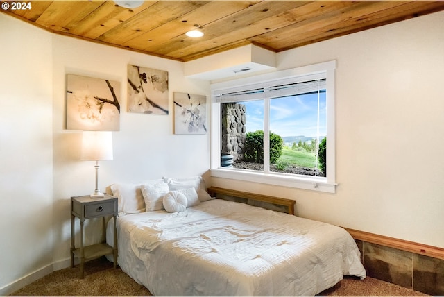 bedroom featuring wooden ceiling and carpet flooring