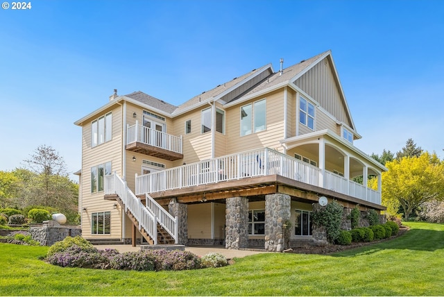 back of property with a lawn and a deck