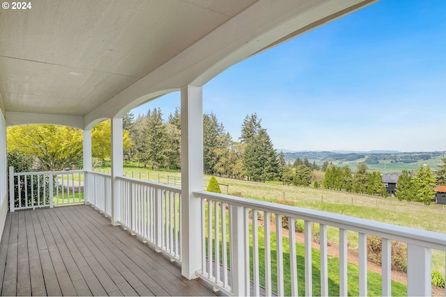 wooden terrace with a yard and covered porch