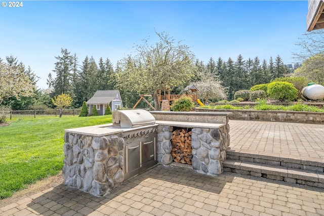 view of patio with a playground and area for grilling