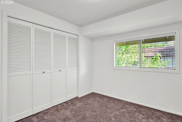 1361 City View St, Eugene, OR 97402 - unfurnished bedroom with dark colored carpet, a closet, and baseboards