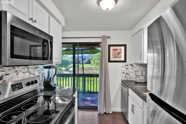 1361 City View St, Eugene, OR 97402 - kitchen with stainless steel appliances, dark countertops, decorative backsplash, and white cabinets