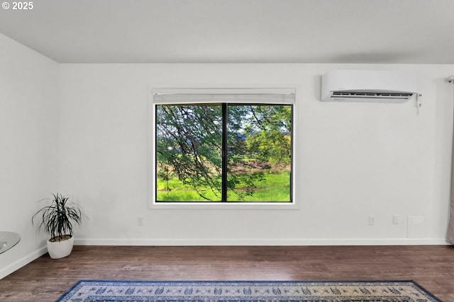 1361 City View St, Eugene, OR 97402 - unfurnished room with a wall unit AC, wood finished floors, and baseboards