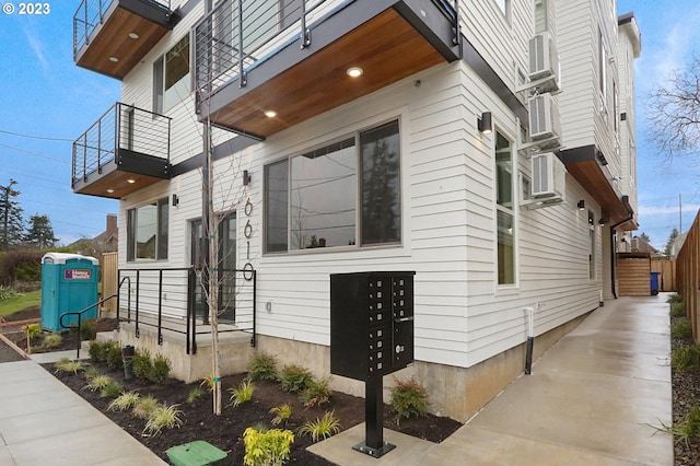 view of home's exterior featuring a balcony and mail boxes