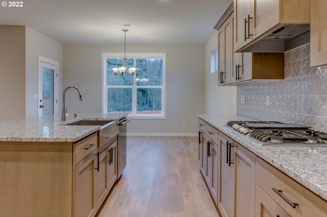 3012 S Nectarine, Cornelius, OR 97113 - kitchen with appliances with stainless steel finishes, light wood-style floors, decorative backsplash, light stone counters, and a chandelier