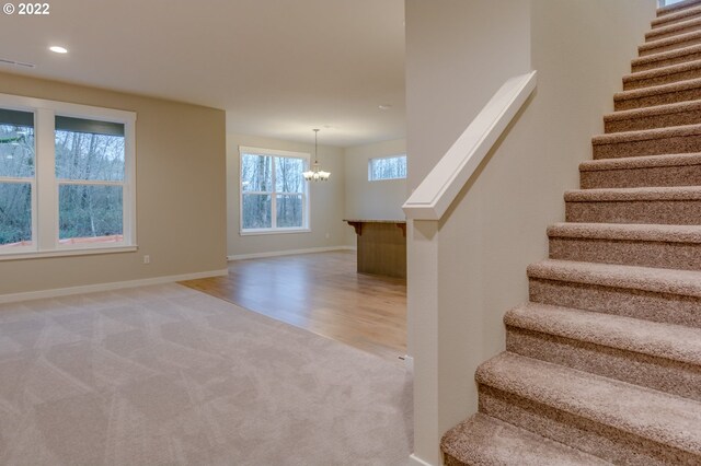 3012 S Nectarine, Cornelius, OR 97113 - stairs featuring carpet floors, a chandelier, baseboards, recessed lighting, and wood finished floors